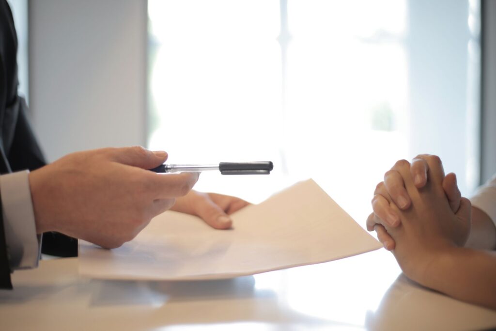 A professional reviews a document with a client before investigation work is agreed